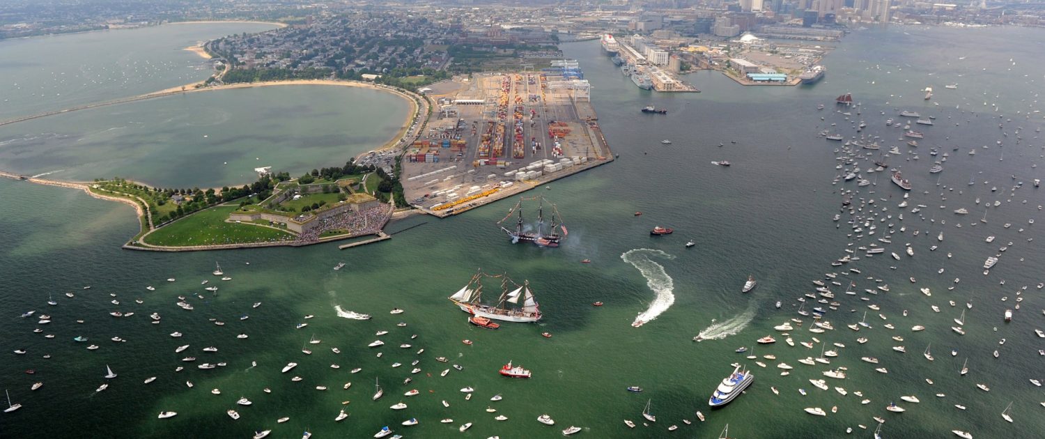 Aerial photograph of Castle Island and Massachusetts Bay with many boats and tall ships