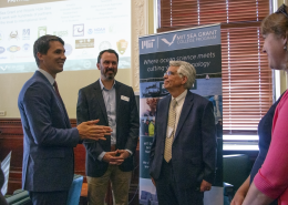 Rep. Dylan Fernandes, Matthew Charette and Michael Triantafyllou talk after a presentation on the Blue Economy at the State House