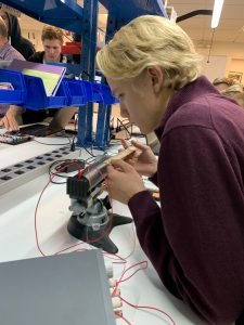 A student working with wires and tools in the MIT Sea Grant Teaching Lab