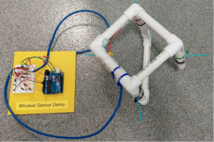 Arduino microcontroller and wiring connected to PVC robot frame