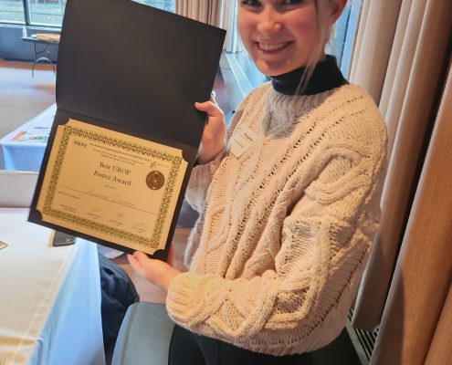 Arianna Ilvonen holds her Best UROP Poster Award certificate from the MIT Mechanical Engineering Research Exhibition.
