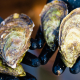 Aquaculturist holding oysters (Photo: North Carolina Sea Grant)