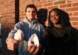 MIT Sea Grant students Santiago Borrego and Unyime Usua hold oyster shells.