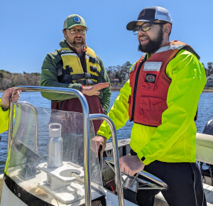 Josh Reitsma from WHOI Sea Grant teaches boating skills to AIM trainee Daniel Hayes-Hillman (Photo by Danny Badger)