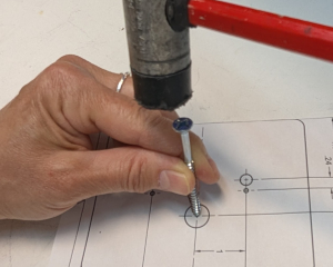 Marking holes with template and woodscrew