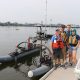 MIT AUV Lab team stands by REX, one of their autonomous vehicles, at the boat dock