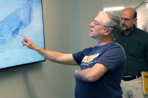 Michael Sacarny pointing to the Charles River map